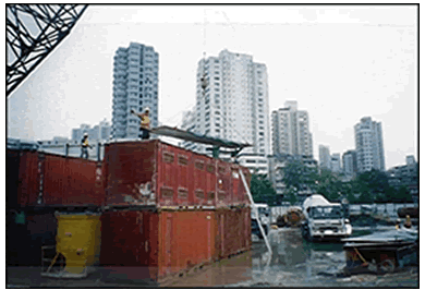 Workers placing roof of the noise enclosure for concrete discharge