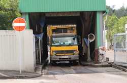 Image of Before leaving the station, the vehicle may have to be washed off residual waste left on the vehicle body at the Vehicle Washing Plant.