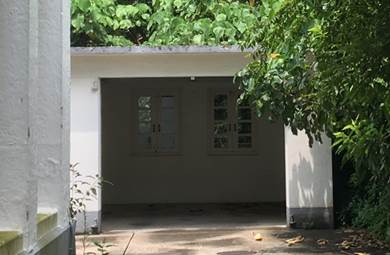 Aerial view of a building surrounded by trees
Description automatically generated