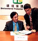 Photo of  Mr. WC Yuen, Senior Environmental Protection Officer updates Mr. Elvis Au, Assistant Director of the Environmental Protection Department on new EIA Ordinance guidance notes for EIA practitioners 