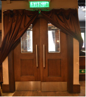 Double-door to reduce noise transmission to outside of the bar