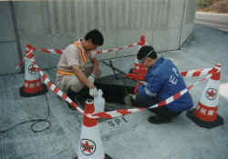 Image of EPD staff takes samples of the effluent regularly to ensure the treatment system is functioning properly to discharge standards.