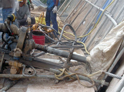 Cover the drill bit with tarpaulin to suppress dust emission during drilling for soil nail
