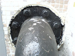 Line pressure pipes that penetrate building structure with flexible materials, such as expanded polystyrene, to absorb the vibration and avoid structural transmission.