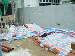 Use plastic sheet to cover up sand, cement and debris to avoid fugitive dust. 