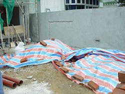 Use plastic sheet to cover up sand, cement and debris to avoid fugitive dust.